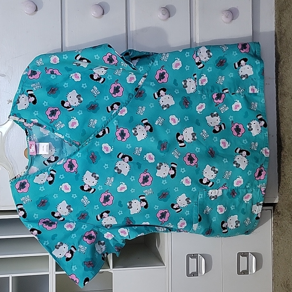 This is a cute used Hello Kitty scrub top 2XL